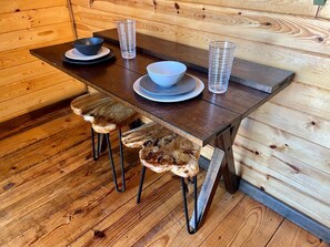 This tiny table folds out for a meal and folds back up for added room.  Plenty of dishes, glassware and utensils for your stay.