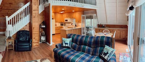 Main space of the middle floor showing the living room kitchen and dining area.