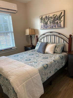 Queen size bed in the second bedroom downstairs