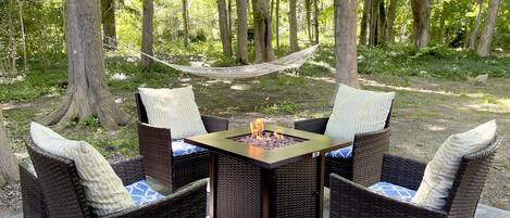 Private backyard with fire pit area and hammock. 