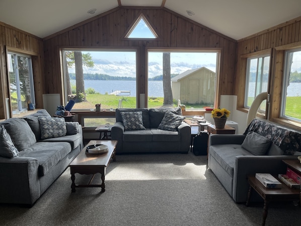Enjoy lake views with windows on three sides of the living room with large TV.