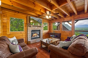 Living room with 55” tv and stone fireplace