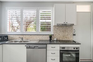 A fully equipped kitchen with a rear door.