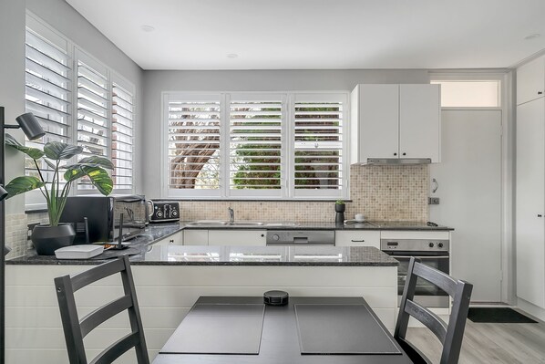 Got to love a white living room and kitchen!