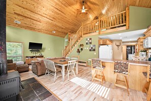 Living area open to dining area, kitchen, and loft. Roku TV, games & puzzles.