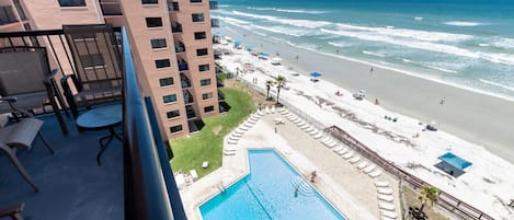 Balcony overlooks pool and ocean