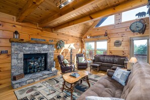 Living room area with gas fireplace and mountain views