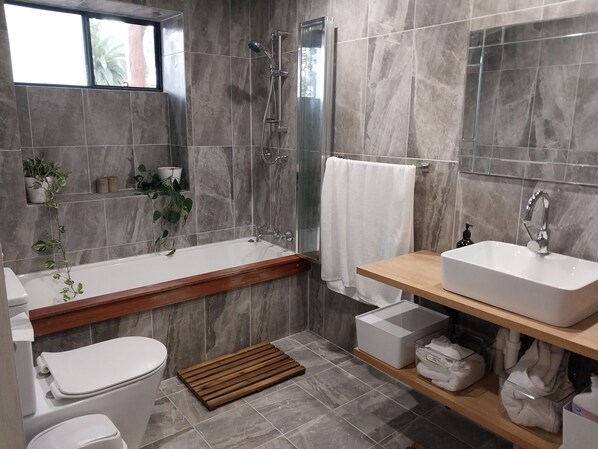 Bathroom with bath and shower  full length mirror 