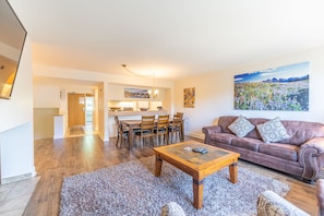 Living area featuring a gas fireplace, mounted TV, and sleeper sofa for additional sleeping options.