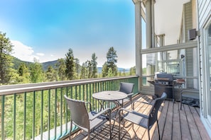 Private balcony offering a grill and seating to take in the mountain views.
