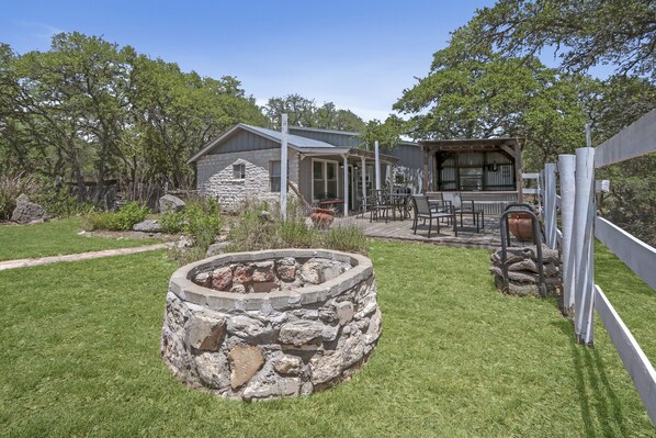 View of fire pit and front of home.