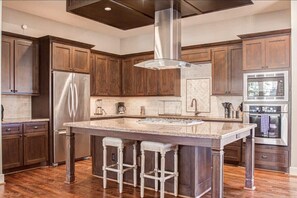 Featuring a kitchen island for ample counter space, loads of cabinet space, and high-end finishes throughout, this gorgeous kitchen is clearly the heart of the home.