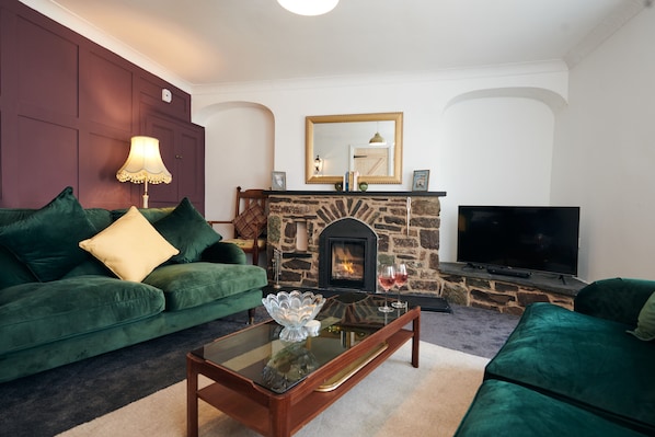 Cosy sitting room with log burner