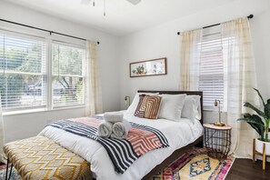 The sun-filled front bedroom with a comfortable queen bed o