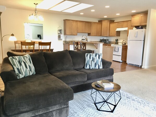 Living room with open kitchen and dining room in the background