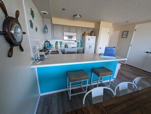 Kitchen has fridge/freezer, oven/stove, microwave, dishwasher, sink w/disposal