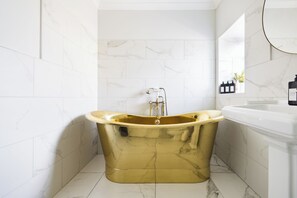 The brass bath at Fern barn, with LED downlights for maximum ambience