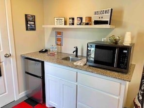 Microwave/convection oven/ air fryer combo, Keurig coffee maker and mini fridge.  
Due to Health Department constraints we only provide disposable cups for the coffee maker.  