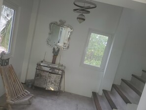 High end chandeliers and mirrored furniture with marble and mahogany stair cases