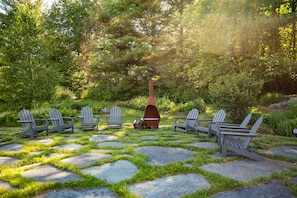 Relax by the pond in the Adirondack chairs and enjoy the fire pit