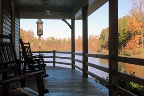 Covered porch w/ rocking chairs and fans.