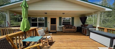 Huge elevated deck with a covered area and large area open to the sunshine.