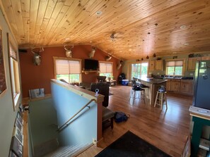 Open living room/kitchen on main level. Stairs down to living room 2/bedroom 4