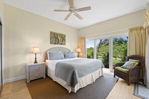 King size bed with deluxe mattress and crisp white linen. Bedside tables and lamps, ceiling fan for those warm summer nights and large garden view windows.