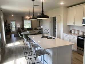 Open kitchen with island.  Quartz countertops.