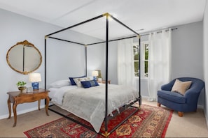 Large master in the rear of the home. En Suite bathroom, closets, & smart TV