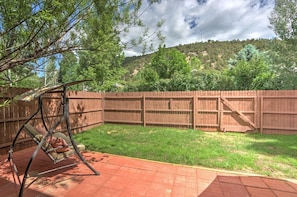 Fenced yard with mountain views and swing seating