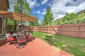 Fenced backyard with patio dining