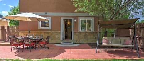 Large patio with outdoor dining and swing