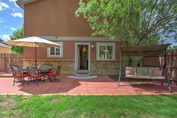 Large patio with outdoor dining and swing