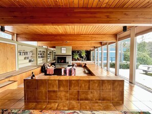 The unique open concept living area's wall of windows look out to mountain views
