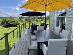 Outdoor dining and lounge area on wrap around porch.