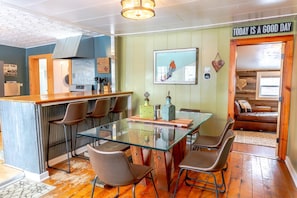 Dining room table seats 6 or more.  Enjoy family meals and board games. Tall kitchen bar with three bar stools. 
