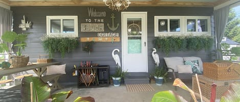 Private Covered Porch has 2 ceiling fans, table for 6  and soft seating. 