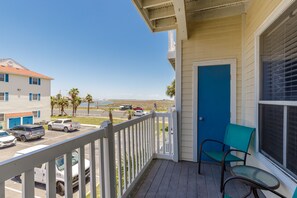 Private balcony on the second floor with table and chairs