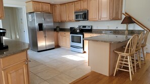 Breakfast bar looking into pantry and first floor laundry room.