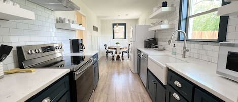 Fresh, clean & fully stocked kitchen.  Light & bright