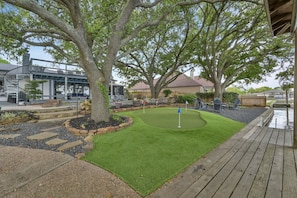 Your outdoor oasis equipped with a putting green, fire pit, & more!