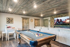 Pool table, another huge TV, and games!