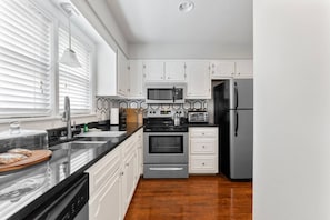 Cozy Stainless Steel Kitchen w/ Granite Countertops