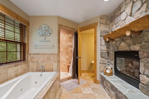 Luxurious master bathroom with a fireplace in operation from October until April