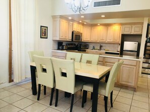 Stylish kitchen studio with dining table and comfortable chairs