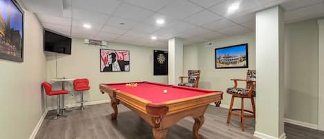 Basement with pool table and dart board
