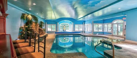 Pool room with hot tub and bar.