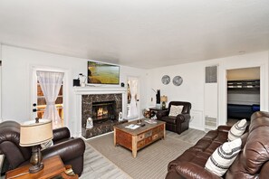 Living room with fireplace. Direct access to Jacuzzi and backyard deck area