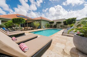 Enjoy your private tropical garden with plenty of comfortable lounge chairs